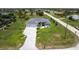 Aerial view of a single Gathering home with a long driveway, well-manicured lawn, and mature landscaping at 291 Rotonda S Blvd, Rotonda West, FL 33947