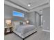 The main bedroom features a neutral color scheme, a tray ceiling, and a large window at 291 Rotonda S Cir, Rotonda West, FL 33947