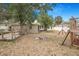 This backyard offers space for recreation, featuring a wooden deck, a fire pit, and a play structure at 3307 W Ballast Point Blvd, Tampa, FL 33611