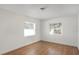 Sunlit bedroom with wood-look flooring and two windows offering plenty of natural light at 3307 W Ballast Point Blvd, Tampa, FL 33611