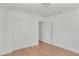 Bright bedroom featuring wood-look flooring and a double-door closet for ample storage at 3307 W Ballast Point Blvd, Tampa, FL 33611