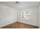 Well-lit bedroom with wood-look flooring and a large window showcasing the neighborhood at 3307 W Ballast Point Blvd, Tampa, FL 33611