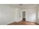 Bedroom with white walls, hardwood floors, closet and hallway access at 3307 W Ballast Point Blvd, Tampa, FL 33611