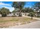 This lovely single-story home features a well-maintained lawn and a beautiful mature shade tree in the front yard at 3307 W Ballast Point Blvd, Tampa, FL 33611