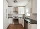 Modern kitchen with stainless steel appliances, granite countertops, white cabinets, and stylish backsplash at 3307 W Ballast Point Blvd, Tampa, FL 33611