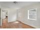 Bright living room features wood floors, a window, and a white door to enhance the space at 3307 W Ballast Point Blvd, Tampa, FL 33611