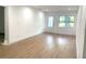 Bright living room featuring neutral paint, recessed lighting, and stylish light wood-look flooring at 3307 W Ballast Point Blvd, Tampa, FL 33611