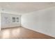Living room with white walls, hardwood floors, a front door, and 2 windows at 3307 W Ballast Point Blvd, Tampa, FL 33611