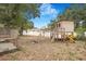 This backyard has a fun play area, featuring a playhouse, swing, and a slide for outdoor adventures and entertainment at 3307 W Ballast Point Blvd, Tampa, FL 33611