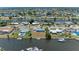 Aerial view of a home in a canal community with waterfront access and palm trees at 149 Roselle Ct, Port Charlotte, FL 33952