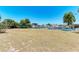 Backyard with a lush lawn, canal, and boat dock at 149 Roselle Ct, Port Charlotte, FL 33952