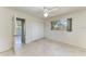 Bedroom features large window, ceiling fan, and closet space at 149 Roselle Ct, Port Charlotte, FL 33952