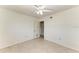 A well-lit bedroom has carpeted floors, a ceiling fan, and an open doorway at 149 Roselle Ct, Port Charlotte, FL 33952