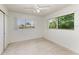 Bright bedroom with two windows and a ceiling fan at 149 Roselle Ct, Port Charlotte, FL 33952