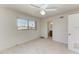 Bedroom with a neutral carpet, window, and doorway to an ensuite bathroom at 149 Roselle Ct, Port Charlotte, FL 33952