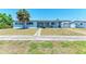 Inviting single-story home with a well-kept front yard and ample parking space at 149 Roselle Ct, Port Charlotte, FL 33952