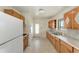 Functional kitchen featuring wood cabinets, white appliances, and ample countertop space at 149 Roselle Ct, Port Charlotte, FL 33952