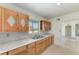 Practical kitchen showcasing wood cabinets, double sink, and a clean, functional design at 149 Roselle Ct, Port Charlotte, FL 33952
