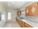 Efficient kitchen featuring wood cabinets, double sink, and a functional design at 149 Roselle Ct, Port Charlotte, FL 33952