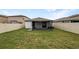 Large backyard featuring a screened-in lanai and a vinyl fence at 15729 Fort Island Pl, Sun City Center, FL 33573