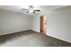 Bedroom featuring a ceiling fan, neutral carpet, and doorway to the bathroom at 15729 Fort Island Pl, Sun City Center, FL 33573