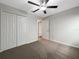 Bedroom featuring a ceiling fan, neutral carpet, and closet at 15729 Fort Island Pl, Sun City Center, FL 33573