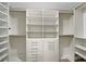 Walk-in closet featuring custom shelving, drawers, and ample storage space at 15729 Fort Island Pl, Sun City Center, FL 33573
