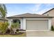 Well-maintained one-story home with a two-car garage, neat landscaping, and a welcoming entrance at 15729 Fort Island Pl, Sun City Center, FL 33573