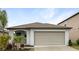 Charming one-story home featuring a two-car garage, landscaped yard, and well-maintained lawn at 15729 Fort Island Pl, Sun City Center, FL 33573