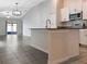 An open-concept kitchen features a breakfast bar, stainless steel appliances, and a tiled floor at 15729 Fort Island Pl, Sun City Center, FL 33573