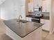 Kitchen with white cabinets, stainless steel appliances, and a large center island with granite countertop at 15729 Fort Island Pl, Sun City Center, FL 33573