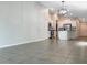 Open concept living area with tiled floors and view of kitchen at 15729 Fort Island Pl, Sun City Center, FL 33573