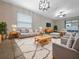 Bright living room featuring stylish furniture, decorative lighting, and a sliding door to the patio at 15729 Fort Island Pl, Sun City Center, FL 33573