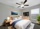 Cozy bedroom featuring a ceiling fan, large window, and stylish decor at 15729 Fort Island Pl, Sun City Center, FL 33573