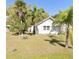 Charming single-story home with lush landscaping, including mature palms, in a sunny location at 744 Myrtle Ave, Venice, FL 34285