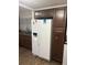 Kitchen area featuring wooden cabinets, granite countertops, a white refrigerator and a stainless steel sink at 744 Myrtle Ave, Venice, FL 34285