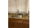 Kitchen sink features a modern faucet, granite counters, and wooden cabinets for ample storage at 744 Myrtle Ave, Venice, FL 34285