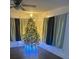 Festive living room with polished wood floors and a bright Christmas tree, creating a warm atmosphere at 744 Myrtle Ave, Venice, FL 34285