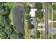 Scenic aerial view of a charming neighborhood and homes adjacent to a tranquil pond at 1937 N Highland Ave, Clearwater, FL 33755