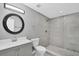 Modern bathroom with a stylish vanity, toilet, and walk-in shower with decorative tile at 1937 N Highland Ave, Clearwater, FL 33755