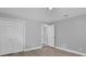 Neutral bedroom with a double door closet and new wood flooring at 1937 N Highland Ave, Clearwater, FL 33755