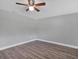 This bedroom features wood-look floors, neutral walls, and a ceiling fan at 1937 N Highland Ave, Clearwater, FL 33755