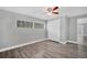 Bedroom featuring new flooring, neutral walls, and double door closet at 1937 N Highland Ave, Clearwater, FL 33755