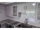 Modern kitchen design featuring a sink, granite counters, and white subway tile backsplash at 1937 N Highland Ave, Clearwater, FL 33755