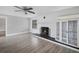 Inviting living room with a decorative fireplace, built-in shelving, and wood-look tile flooring at 1937 N Highland Ave, Clearwater, FL 33755