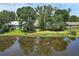 Tranquil pond reflecting homes and trees, offering a serene view of neighborhood nature at 1937 N Highland Ave, Clearwater, FL 33755