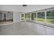 Bright sunroom features tile flooring, large windows, and easy access to the outdoors at 1937 N Highland Ave, Clearwater, FL 33755