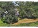 Charming home nestled among mature trees and a lush green yard, enhancing privacy at 1937 N Highland Ave, Clearwater, FL 33755