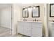 Bathroom featuring a double vanity with a framed mirror and modern lighting at 2901 26Th W St # 317, Bradenton, FL 34205