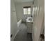 Bathroom featuring a bathtub, white vanity, subway tiles and gray flooring at 1836 1St E Ave, Bradenton, FL 34208